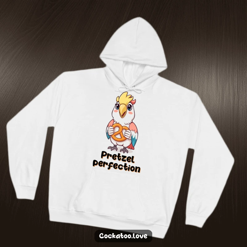 Funny hoodie featuring a happy cockatoo holding a tiny pretzel, offering comfort and a snack-loving vibe.