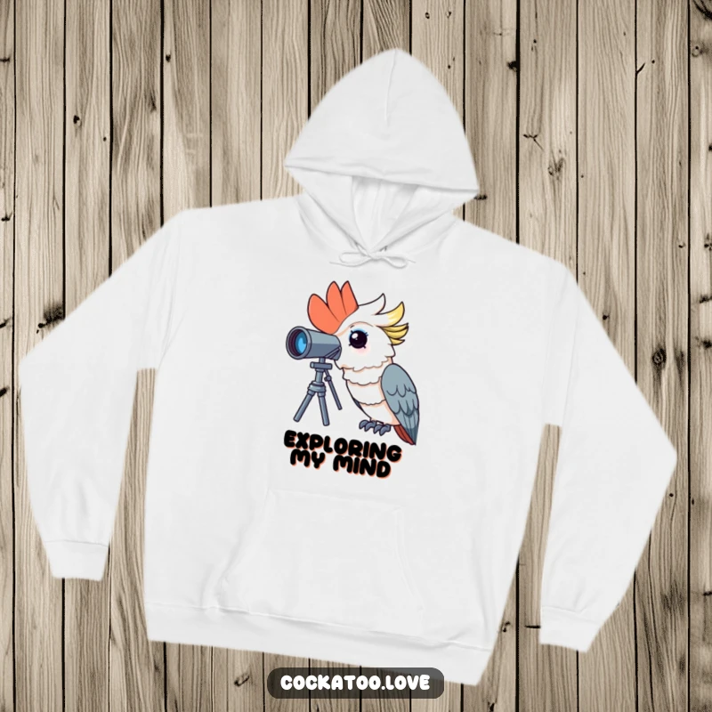 Funny cockatoo hoodie depicting a curious bird peering through a telescope with wide-eyed wonder, perfect for cozy exploration.