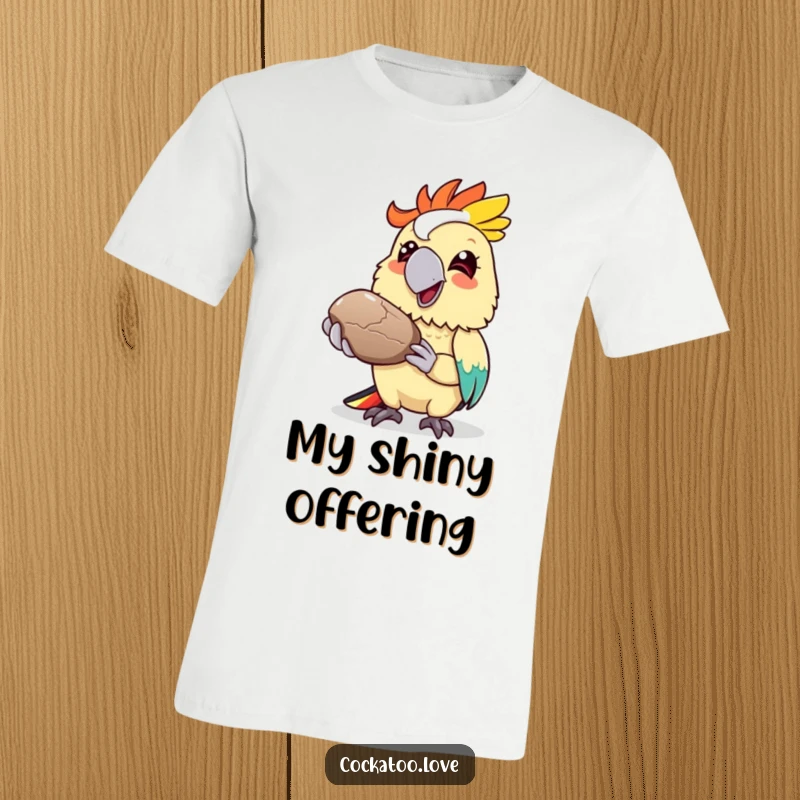 Funny cockatoo t-shirt, colorful bird character offering a shiny pebble with a grin, cheerful and kind design.
